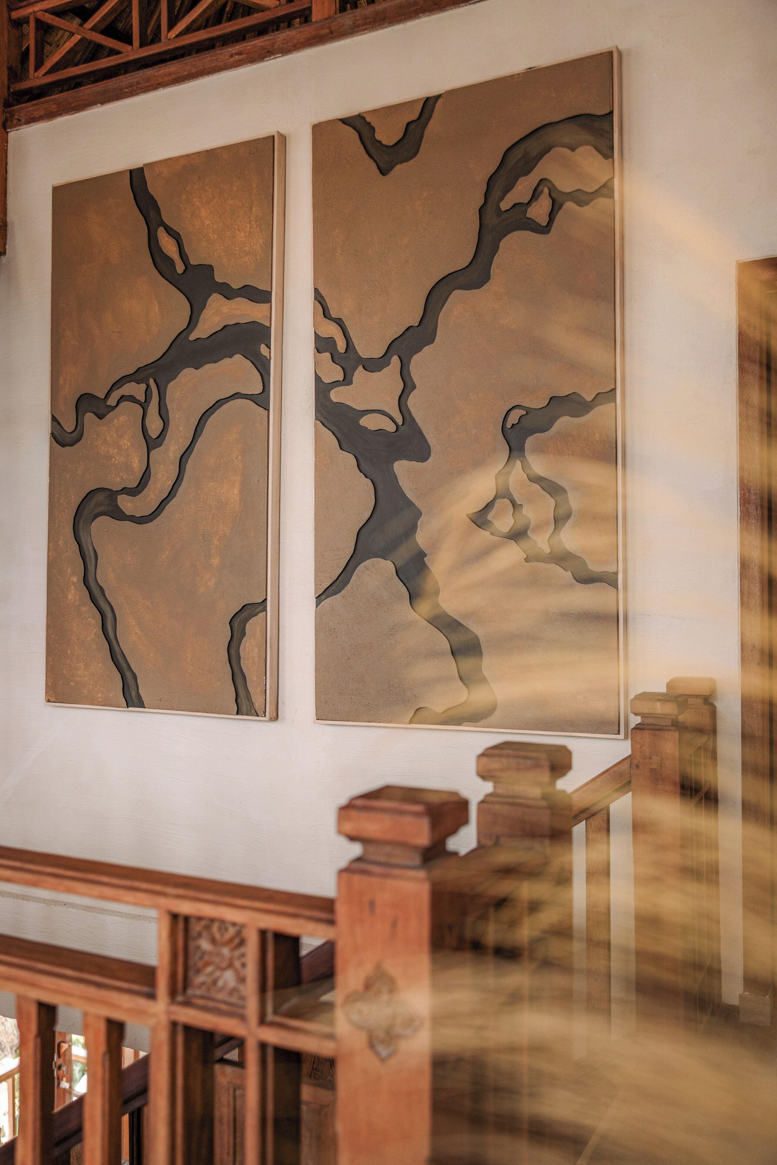 Two abstract paintings on a wall.