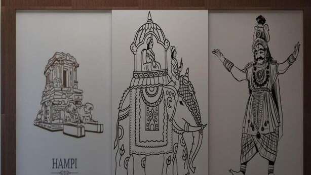 Obra enmarcada que representa un templo, un elefante y una figura con vestimenta tradicional.