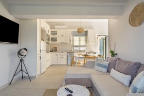 A modern living room with a sofa, a coffee table, and a TV.