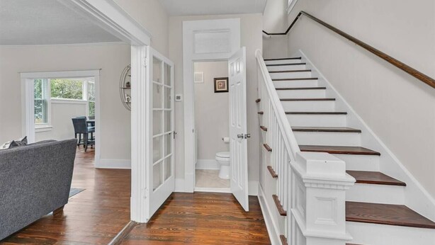 A staircase with white railings and wooden steps leading to an upper floor. - Masters Classic AUGUSTA (Augusta)
