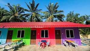 A colorful building with numbered doors and outdoor seating.