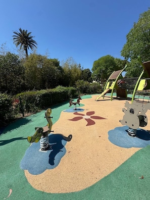 A playground with a slide, swings, and a climbing structure.