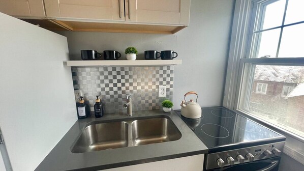 Fridge, coffee/tea maker, toaster, cookware/dishes/utensils