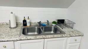 Fridge, coffee/tea maker, toaster, cookware/dishes/utensils