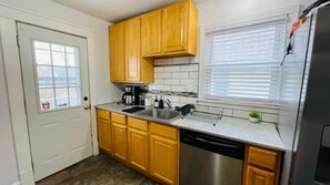 Fridge, cookware/dishes/utensils, dining tables