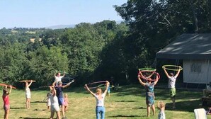 A group of people outdoors on a grassy field, some holding hula hoops. - Spacious mobile home with terrace - 6 people (Argences-en-Aubrac)
