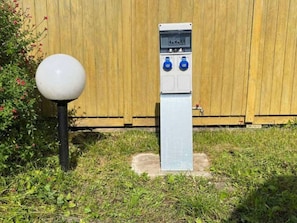A utility box with two blue switches and a white spherical object nearby. - Cozy chalet with terrace for 4 people (Gurmençon)
