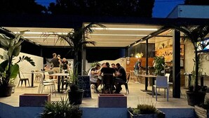 An outdoor dining area with tables and chairs, surrounded by potted plants. - Mobile Home with Terrace in Bormes-les-Mimosas (Bormes-les-Mimosas)