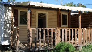 A single-story mobile home with a wooden deck and a covered porch. - Mobile Home with Terrace in Bormes-les-Mimosas (Bormes-les-Mimosas)