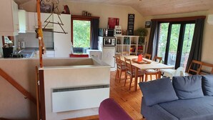 A compact living space with a kitchenette, dining area, and seating.