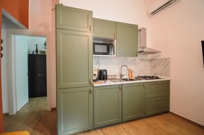 Fridge, microwave, stovetop, coffee/tea maker