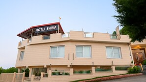 A multi-story hotel named 'Hotel Shiva' with a flat roof, large windows, and a gated entrance. - Hotel Shiva Lake - Near Mussoorie Lake (Mussoorie)