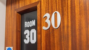 A wooden door with a sign indicating "ROOM 30" and a "Fire door keep shut" sign. - Hullywood Rooms (Hull)