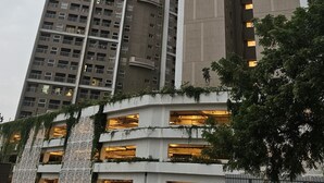 A high-rise building with multiple floors, large windows, and a modern architectural design.