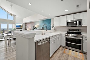 Fridge, microwave, oven, stovetop - Aventurra 403 — Modern Beach Block Penthouse Oasis with Rooftop Pool, Bay Views & Walkable Fun — Sleeps 9 (Ocean City)