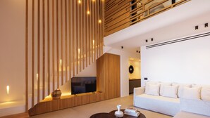 A modern living room with a sofa, coffee table, TV, and wooden slatted wall. - Panormos Bay Collection (Mykonos)
