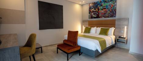 A modern bedroom with a bed, a desk, and a chair.