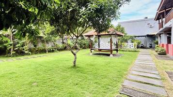 A well-maintained garden with a stone pathway leading to a gazebo.