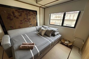 Studio | Desk, laptop workspace, blackout drapes, bed sheets