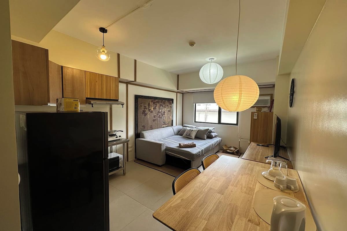 Desk, laptop workspace, blackout drapes, bed sheets