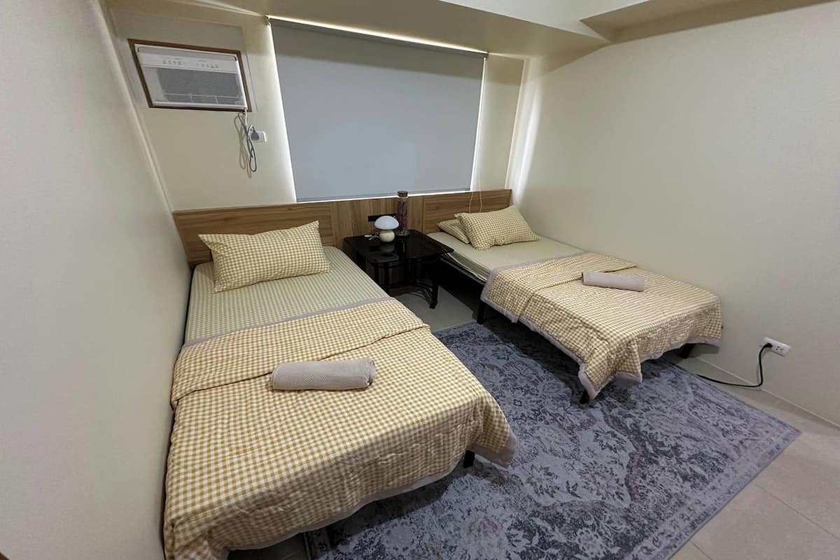 Desk, laptop workspace, blackout drapes, bed sheets