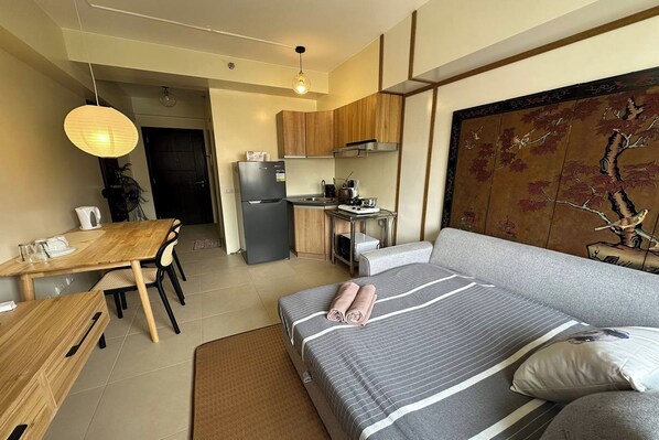 Studio | Desk, laptop workspace, blackout curtains, bed sheets