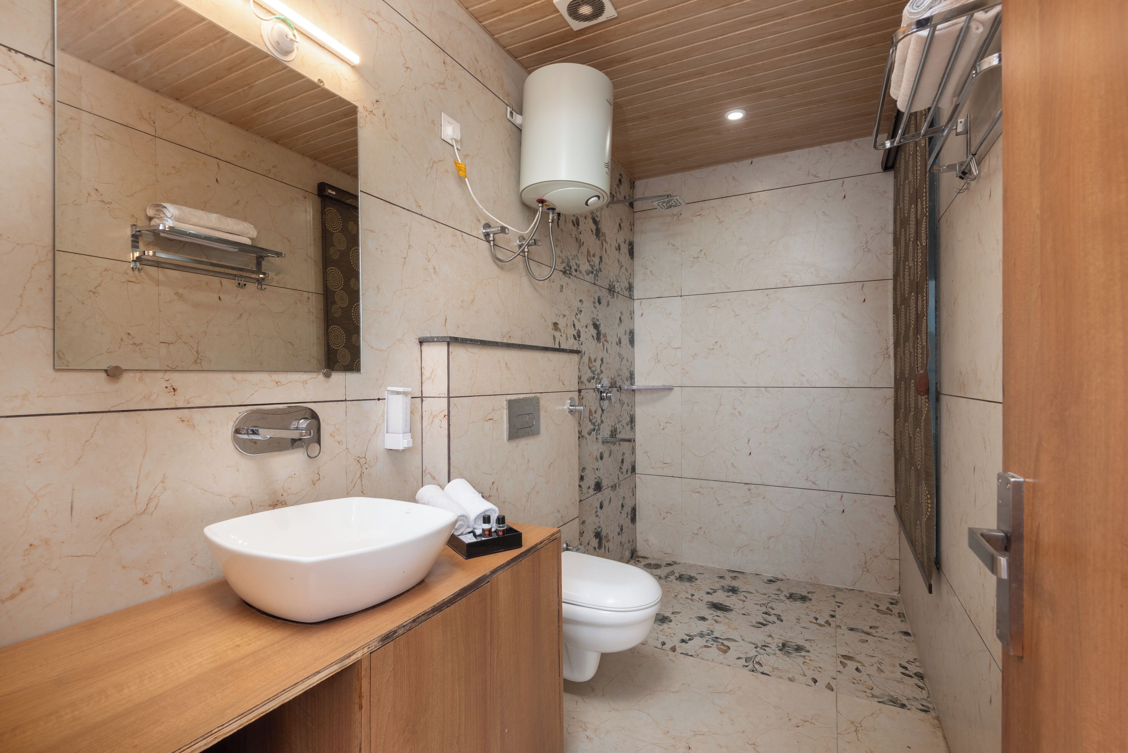 A modern bathroom with a large sink, toilet, and shower.