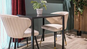 A modern dining area with a table and four chairs, a framed picture on the wall, and a potted plant. - Boutique Studio with Designer Finishes – APT 16 (South Yorkshire)