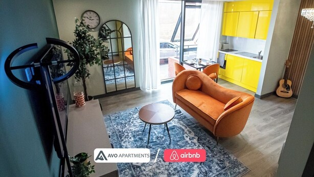 Un appartement moderne comprenant un salon, une cuisine et un coin repas.