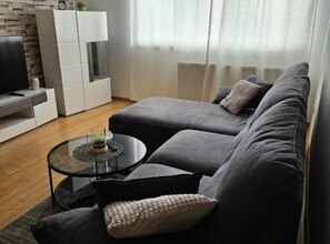 Apartment (One Bedroom Apartment) | Living room | 32-inch flat-screen TV with satellite channels