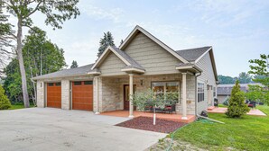 A two-story house with a stone facade, a covered front porch, and a garage. - Serene 1/3 Acre-families, Exec, Mayo (Pine Island)