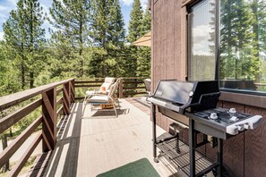 A deck with a grill, lounge chairs, and a view of a forest. - 6 Mi to Downieville Downhill: Cabin w/ Mtn Views (Sierra City)