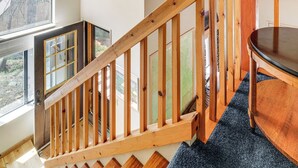 A wooden staircase with a glass door leading to a balcony. - 6 Mi to Downieville Downhill: Cabin w/ Mtn Views (Sierra City)