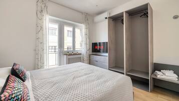 Laptop workspace, iron/ironing board, bed sheets