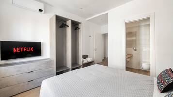 Laptop workspace, iron/ironing board, bed sheets