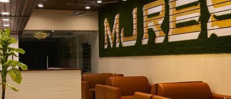 A lobby with a reception desk, seating area, and a wall with the word "MUREX" in large letters.