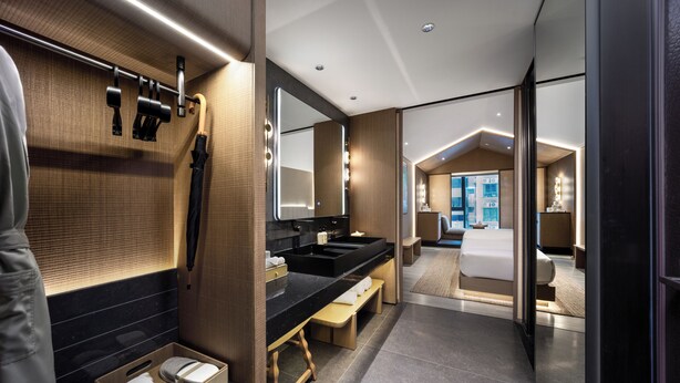A modern bathroom with a vanity, mirror, and bench. - Healing mind International Hotel Guangzhou Tianhe Sports Center Linhexi Metro Station Branch (Guangzhou)