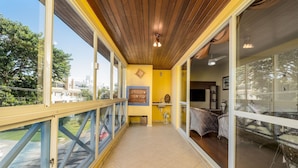 A balcony with a wooden ceiling, glass railings, and a view of the city. - Apt With Grill 300m From the Beach Mdo201 (Florianópolis)