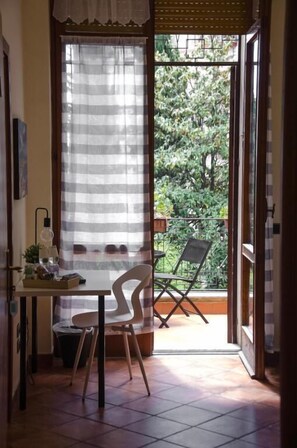 Desk, laptop workspace, blackout drapes, iron/ironing board