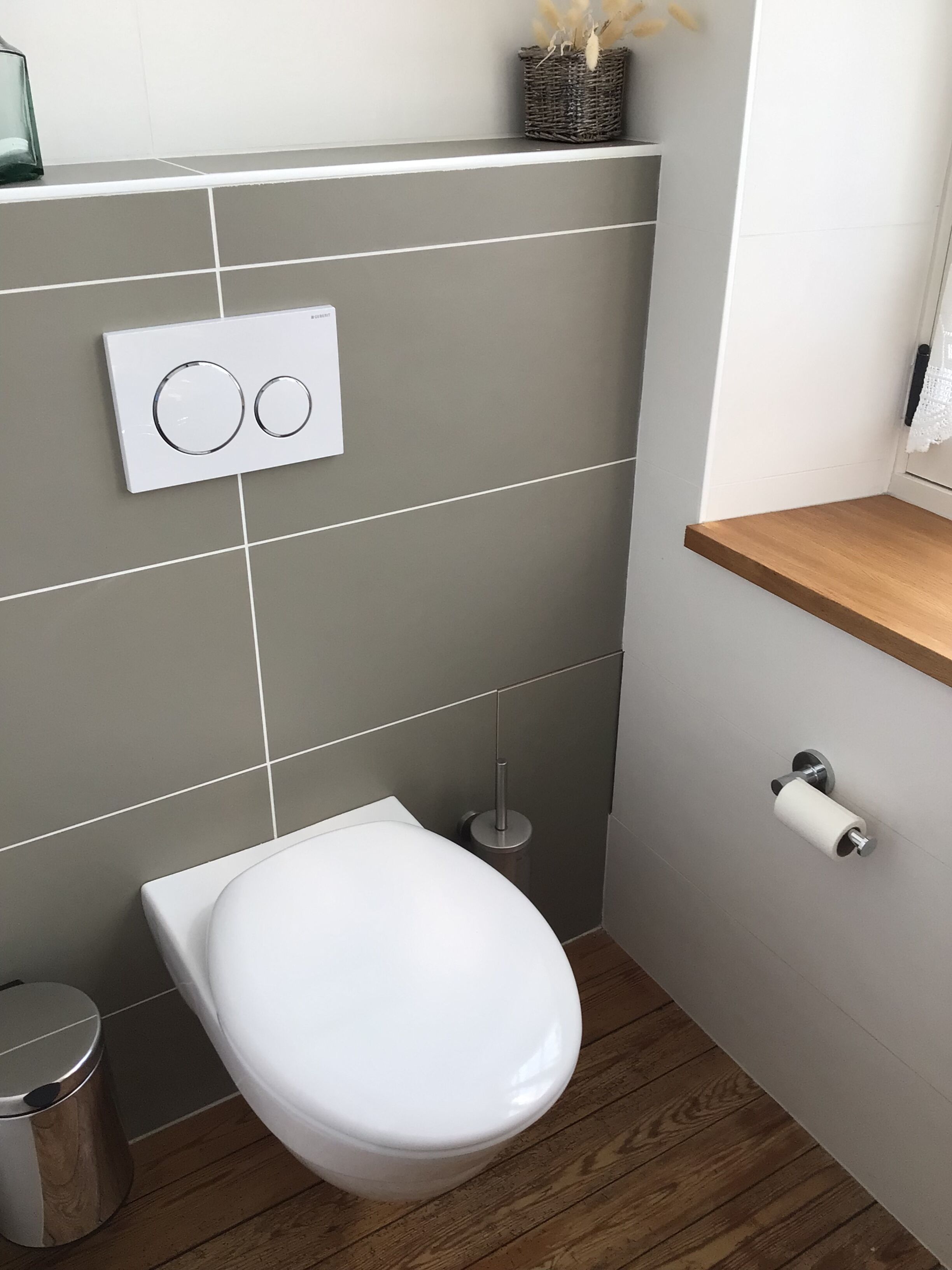 Un baño moderno con inodoro, bidé y cubo de basura.
