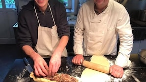 Two individuals in a kitchen preparing food, with a rolling pin and dough on the counter. - La Galotiere  (Coteaux-sur-Loire)