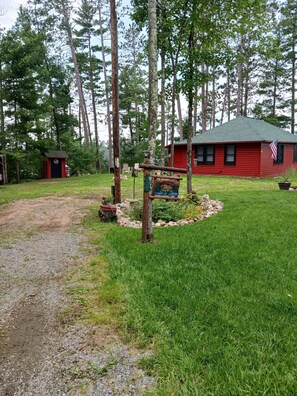 Property grounds - Peaceful 2-bedroom cabin in Elcho on Lower Post Lake. (Elcho)