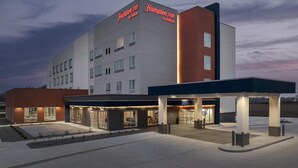 A modern hotel with a prominent sign, a covered entrance, and a well-lit exterior. - Hampton Inn By Hilton Dexter (Dexter)