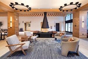 A modern interior with a fireplace, seating area, and wooden accents.