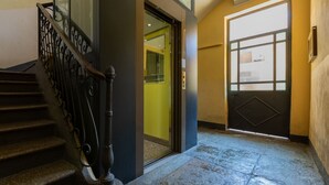 A staircase with ornate metal railings leading to a door with a geometric pattern. - Riflessi sul Po by Wonderful Italy (Torino)
