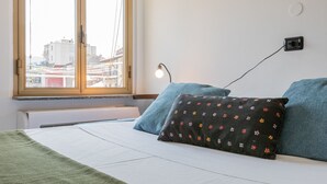 A bedroom with a bed, a window, a wall socket, and a radiator. - Riflessi sul Po by Wonderful Italy (Torino)