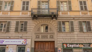 A building with a central entrance, multiple windows with shutters, and a small balcony with ornate railings. - Riflessi sul Po by Wonderful Italy (Torino)