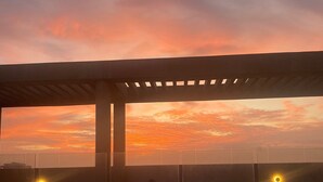 A rooftop pool with a sunset view, a pergola structure, and a city skyline in the background. - Apartment 9th Floor Luxury Suites District (Barranquilla)