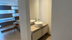 A modern bathroom with a large mirror, two sinks, and a glass partition. - Apartment 9th Floor Luxury Suites District (Barranquilla)
