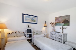 A room with two beds, a nightstand, a dresser, a lamp, and two paintings on the wall. - Sea and Canopy Rooms: Mountain View, Shared Terrace and Garden (SARROLA CARCOPINO)
